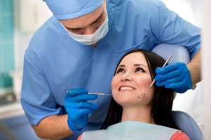 young doctor dentist examines the mouth of the patient