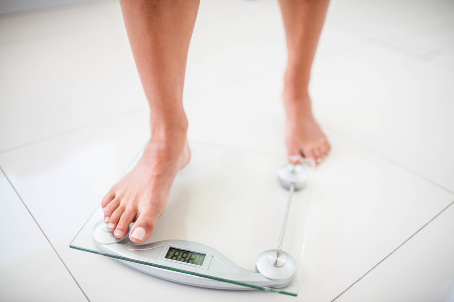 Woman stepping on scale